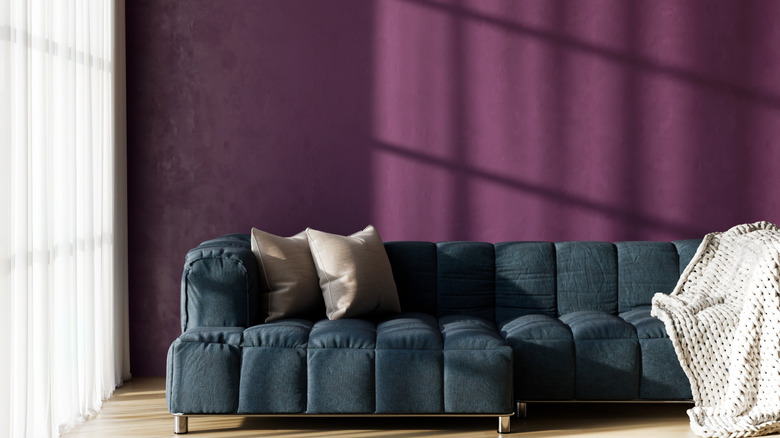 A luxurious living room with rich purple walls