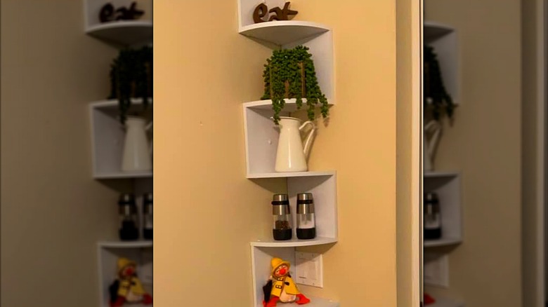 CD tower mounted to wall and used for holding decorations and stored items in a kitchen