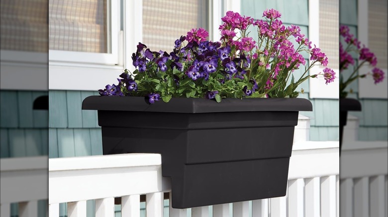 Root & Vessel deck railing planter installed on deck and full of flowers