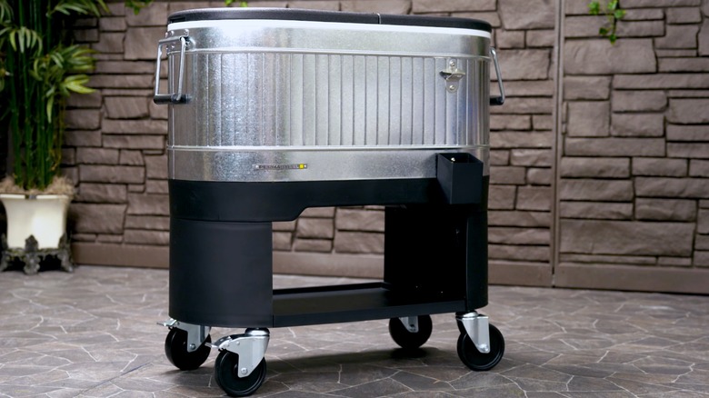 Permasteel 120-quart Steel Rolling Cooler on tidy patio