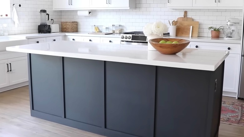 Builder-grade kitchen island renovated with new trim and black paint