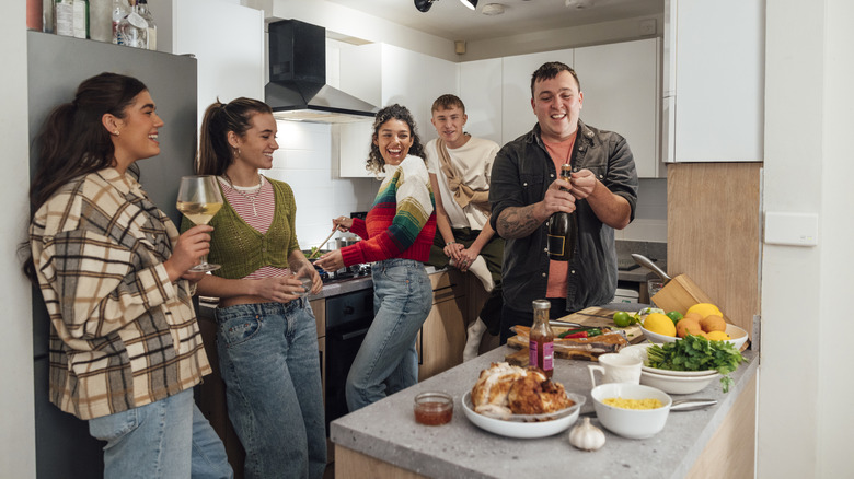 Friends laughing together in the kitchen