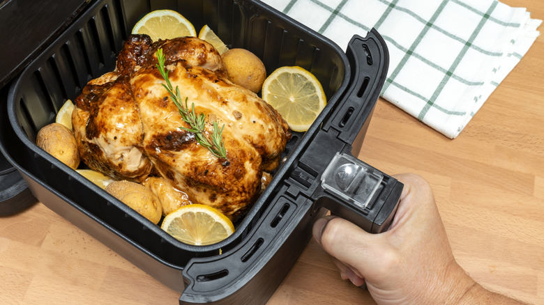 whole roasted chicken with potatoes and lemon in air fryer