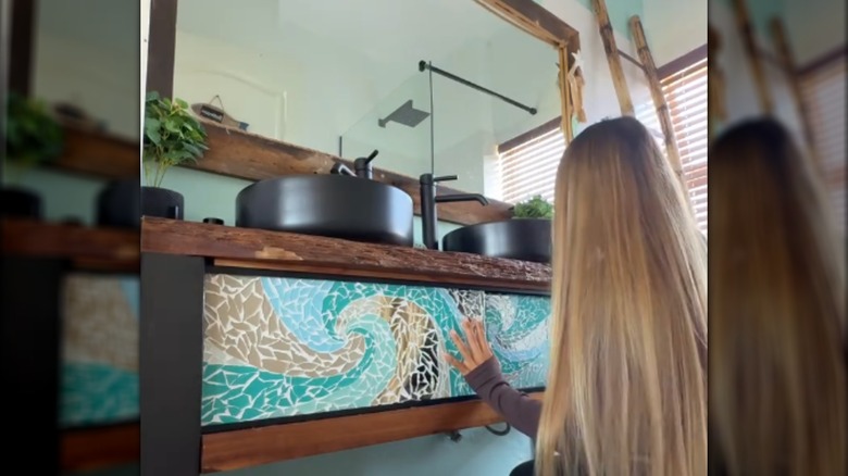 Creator sliding mosaic panels onto her bathroom vanity