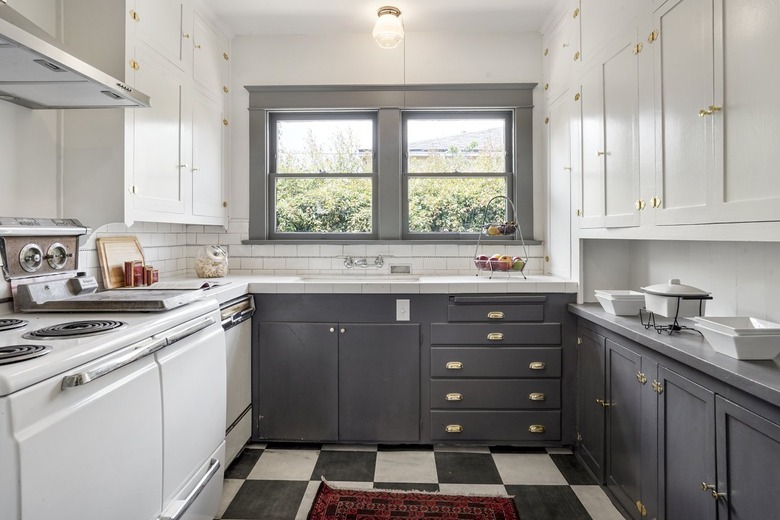 craftsman kitchen with two tone cabinets in gray and white and checkerboard floor