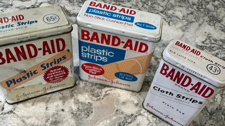 Three vintage band-aid tins