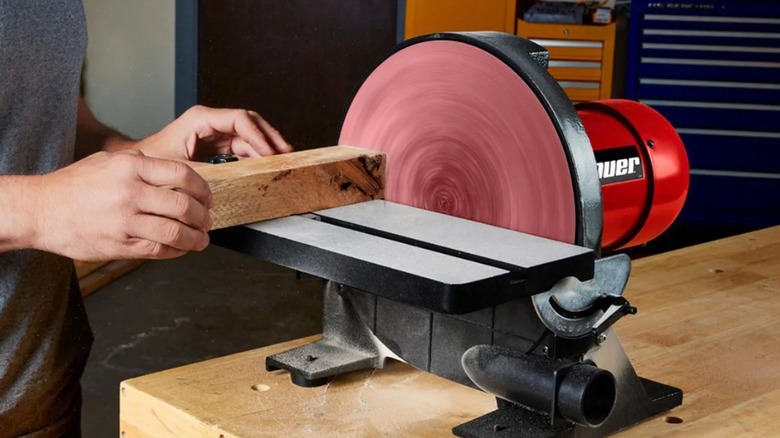 Person shaping wood with a Bauer Disc Sander