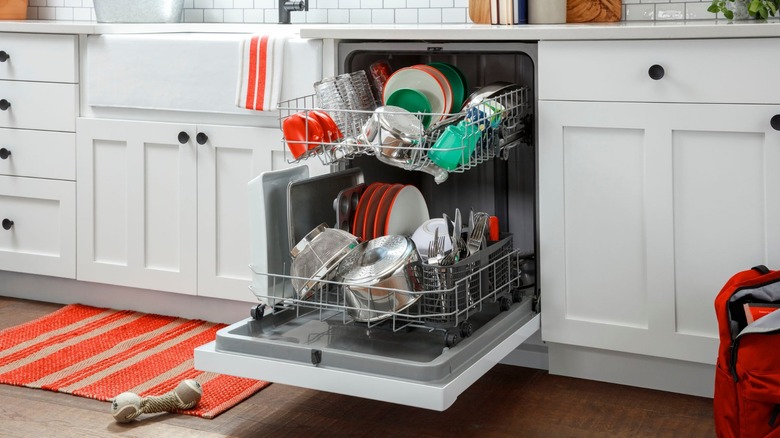 Open Hotpoint HDF330PGRWW dishwasher full of dishes