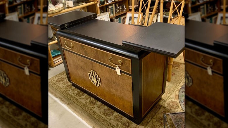 A Chin Hua burlewood and brass server in a thrift store