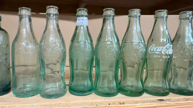 A line of vintage Coca Cola bottles