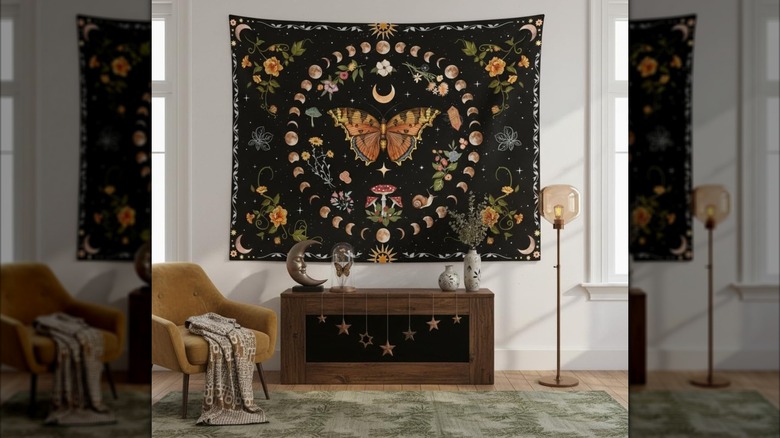 a large, bold tapestry featuring a large butterfly hangs on the wall of a white living room