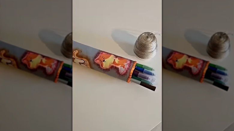 A pencil/marker holder made from detergent caps and toilet paper rolls