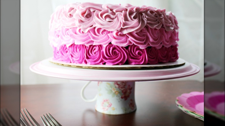 Cake stand made from floral coffee cup glued to cake platter