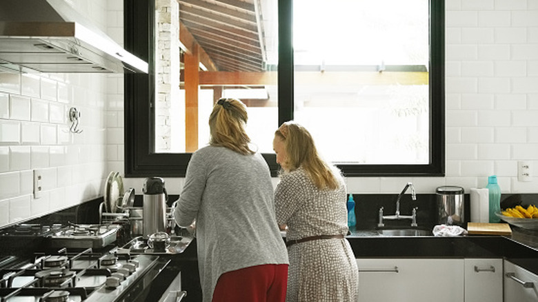 Two women preparing food together