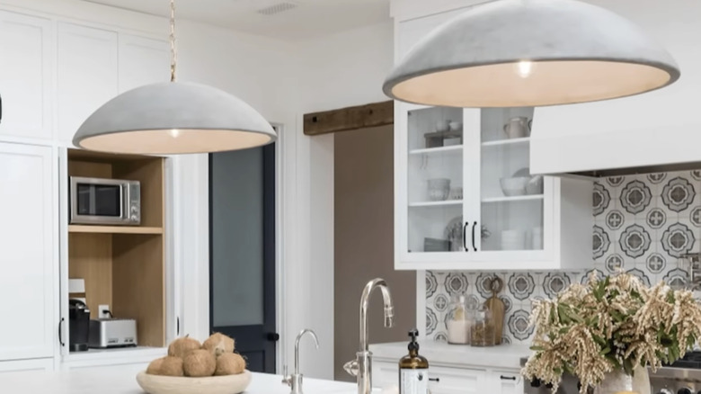 Modern kitchen with big saucer-style pendant lights