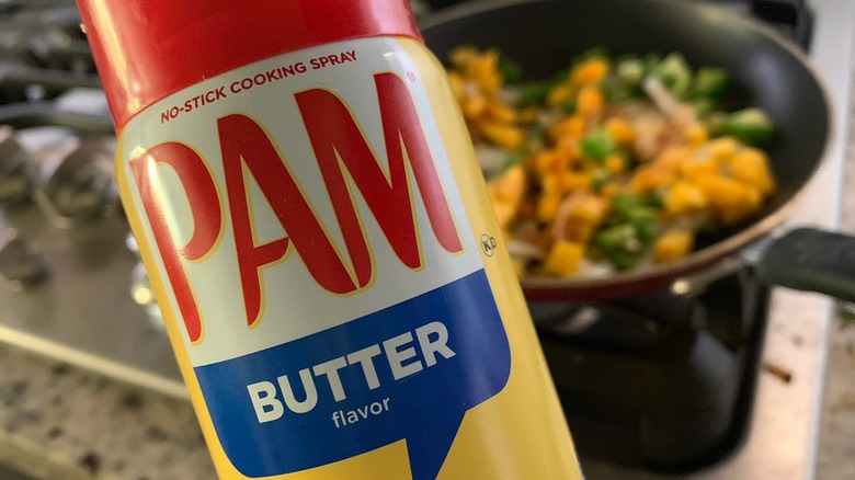 A can of PAM vegetable oil spray with a frying pan in the background