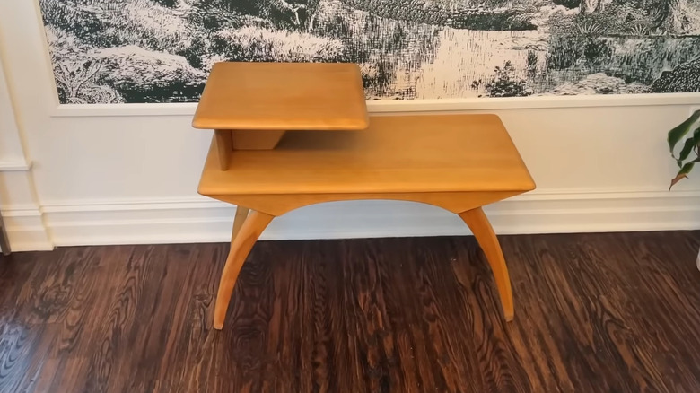 A Heywood-Wakefield two-tiered step table on a wooden floor