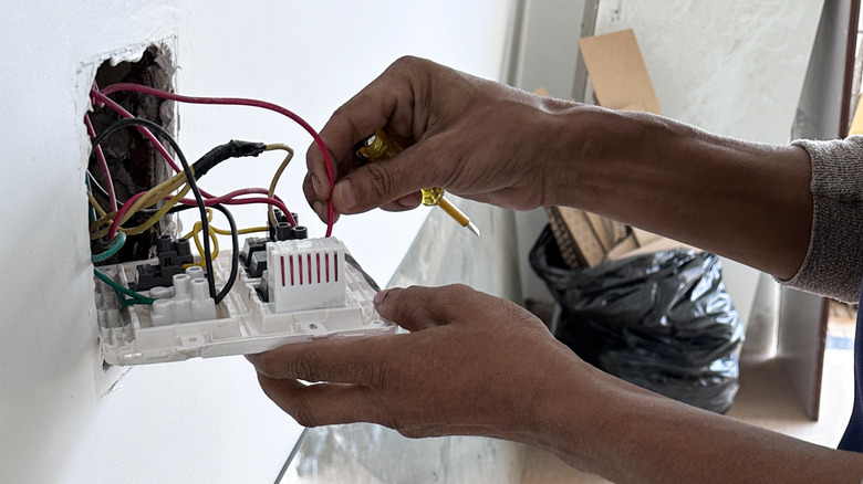 Person doing work on eletrical outlet