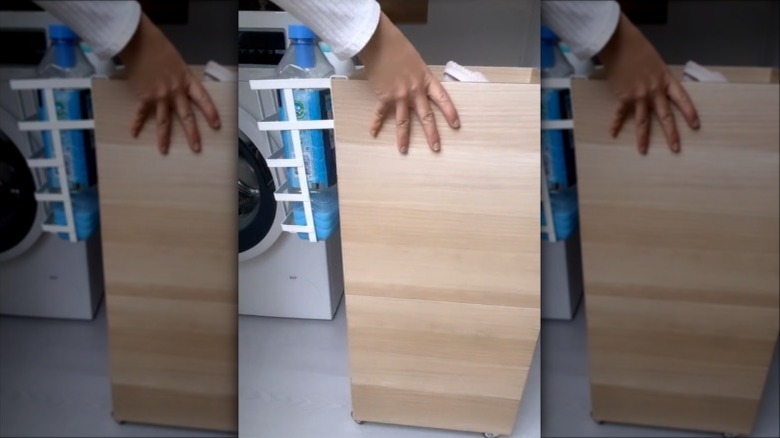 Laundry hamper made from IKEA cabinets beside a washing machine