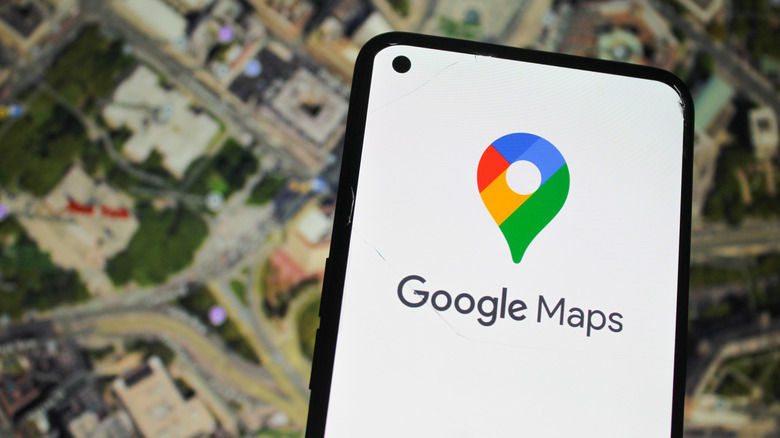 A phone shows the Google Maps icon with a satellite image of a neighborhood in the background.
