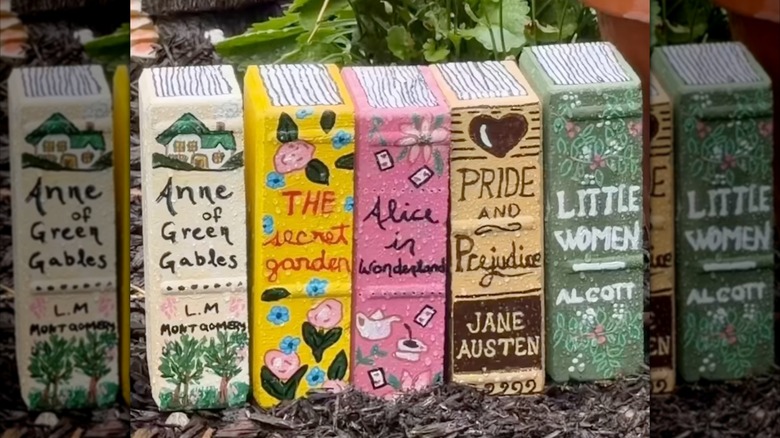 Foam bricks painted into books in a garden