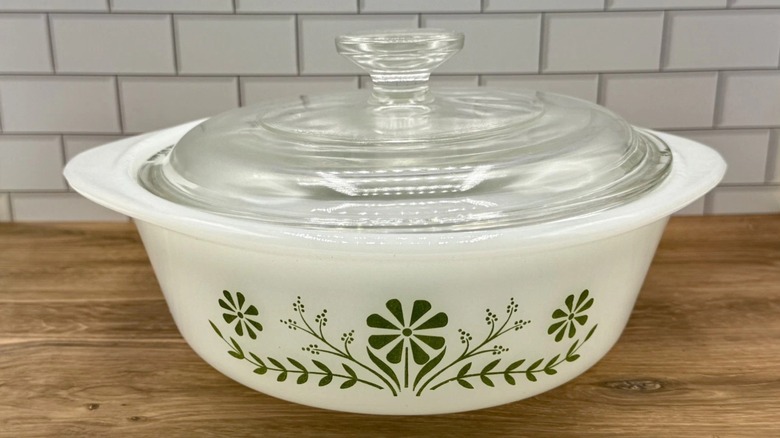 A vintage Glasbake casserole with floral pattern and clear glass lid