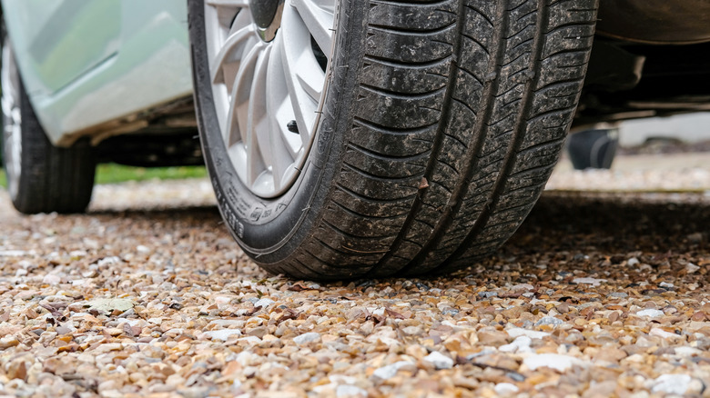 Car tire on the gravel driveway
