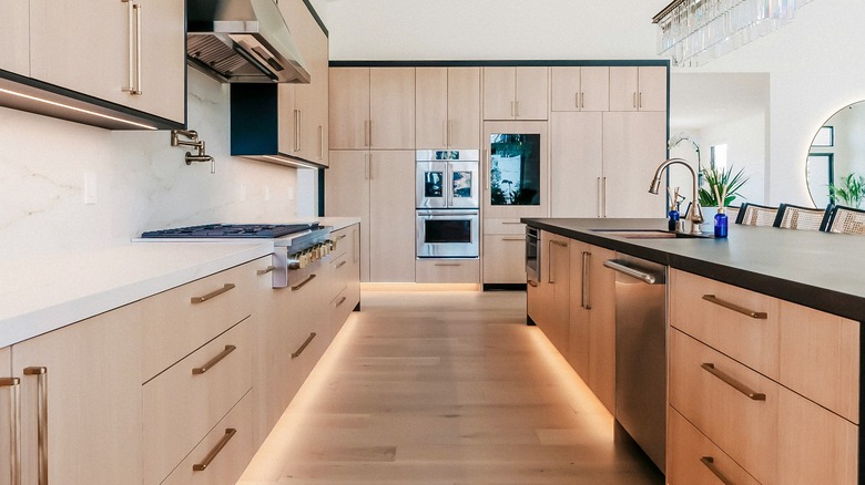 Light wood cabinets in a predominantly white kitchen