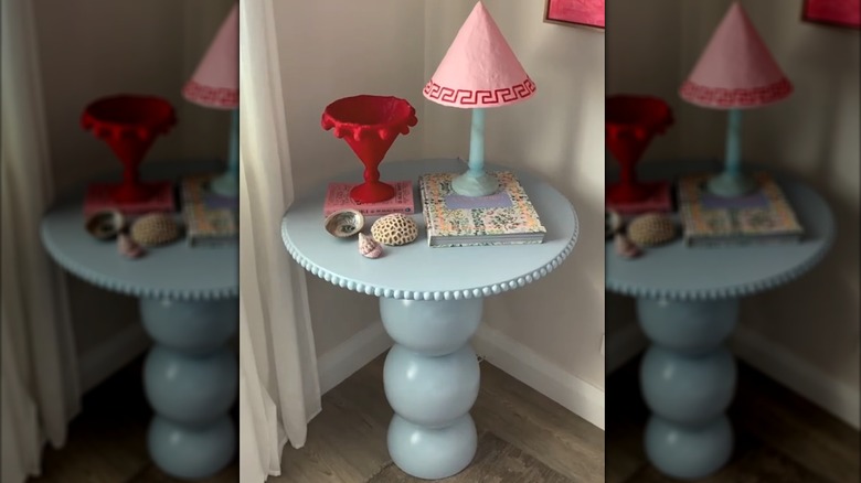 Light blue retro table made from repurposed IKEA products with whimsical decor in room corner
