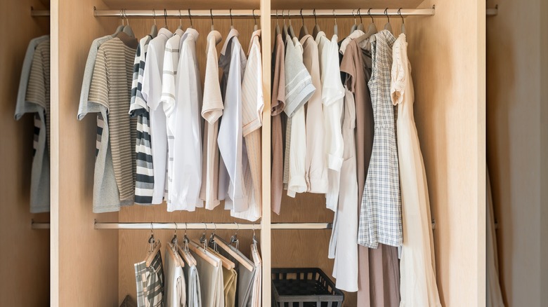 A small closet with a second rod on both sides