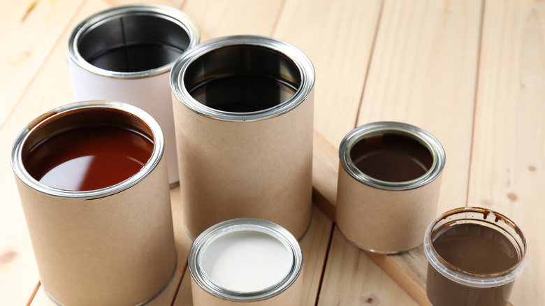 Various cans of differing colored oil stain