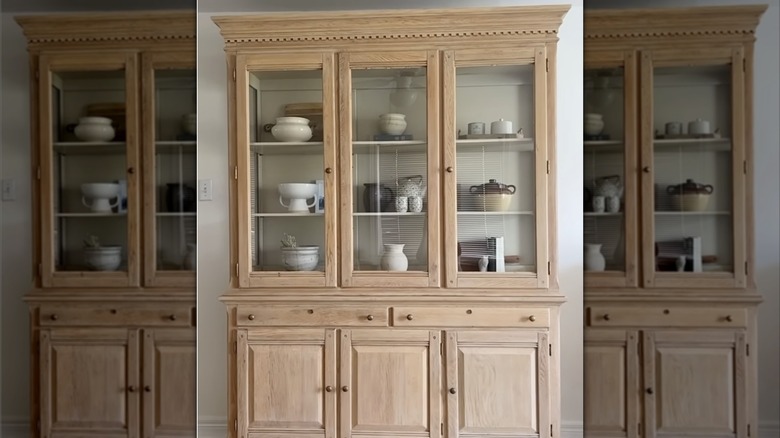 A DIY oak hutch for the dining room with dishware and accessories