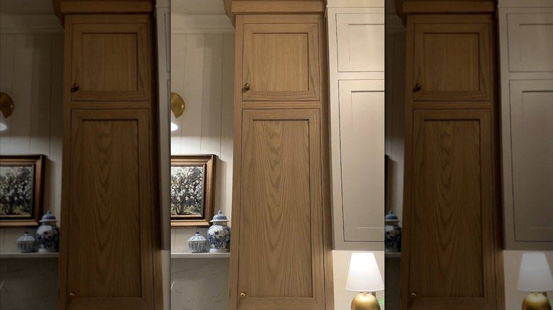 A red oak kitchen cabinet with green stain