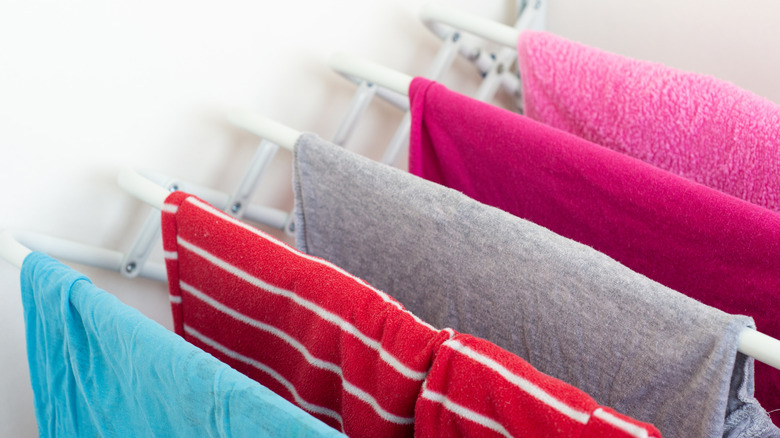 Laundry rack with colorful garments draped over rods
