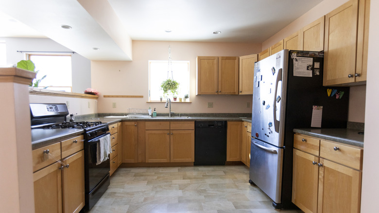dated kitchen with black countertops