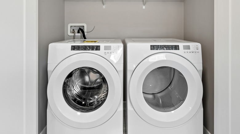 two dryers in a utility room