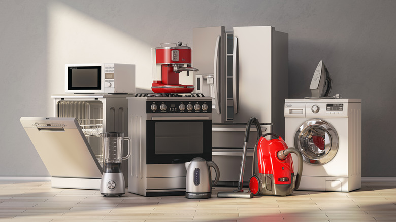 Wide shot of several appliances, including an oven, refrigerator, dishwasher, and microwave