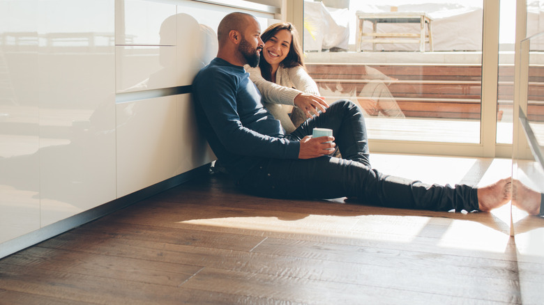 Young couple sitting on their new kitchen floor