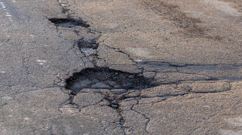 Cracks and pothole on asphalt