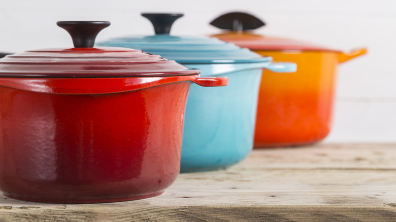 Colorful Le Creuset dutch ovens in a row