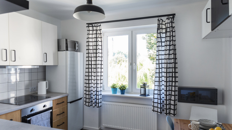 Modern kitchen with curtains on windows