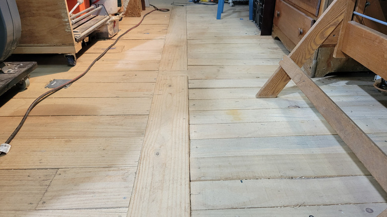 A level pine floor built on floating 5x10 wood pallets