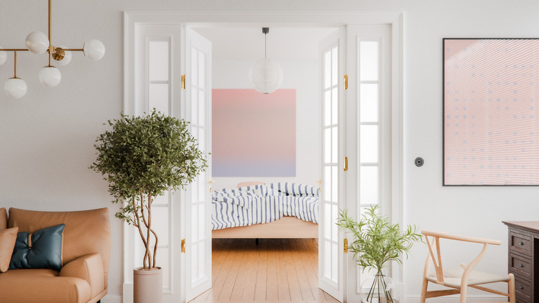 A modern open double french door from living area to bedroom