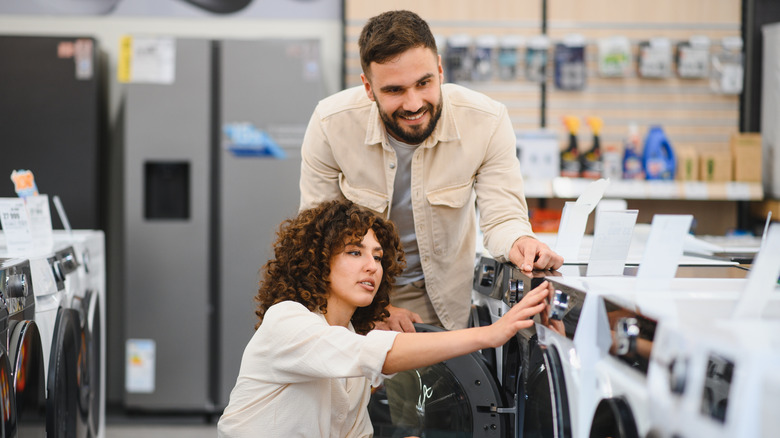 Couple shopping for washing machine