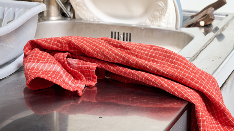 Close-up of kitchen towel tossed on counter beside sink