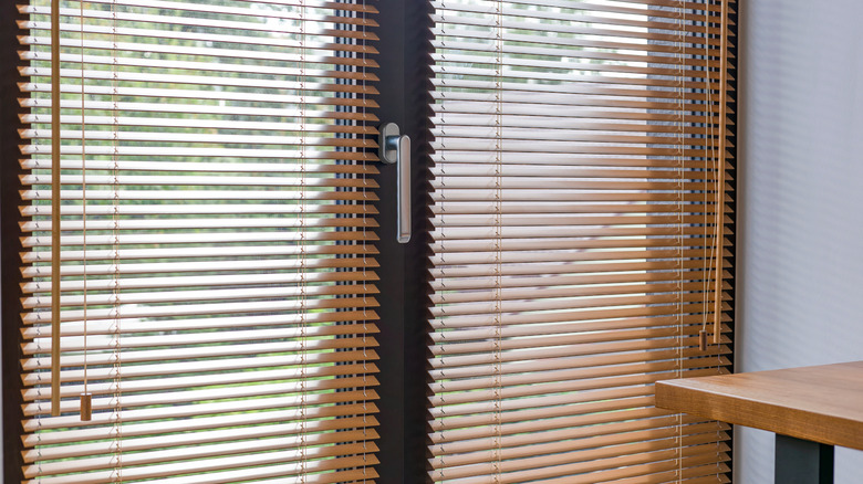 Glass patio doors with blinds over windows