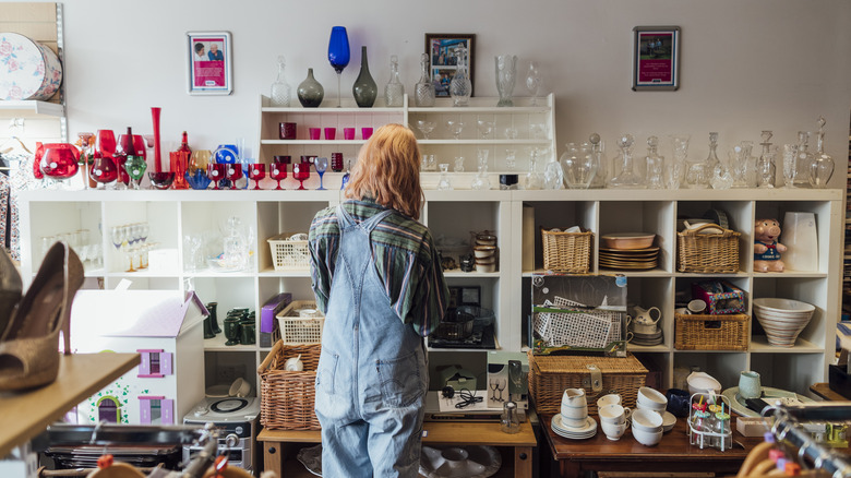 A person looking at items in a thrift store.