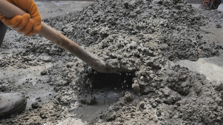 Worker mixing up concrete mixture