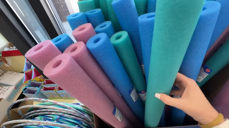 Shopper grabbing a pool noodle out of a box