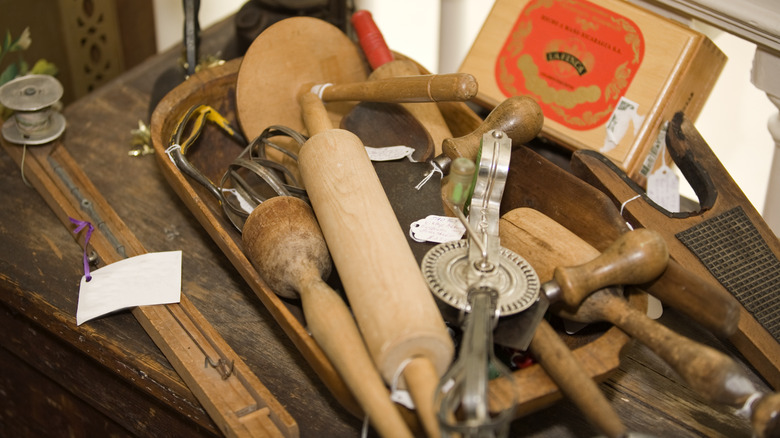 A collection of vintage kitchen tools in a secondhand store